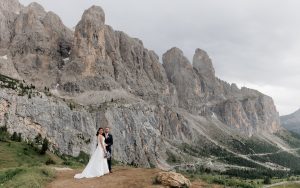 Bride and Groom overlooking on Passo Gardena, a romantic and exclusive wedding at Kolfuschgerhof Colofosco, Dolomites everywhere